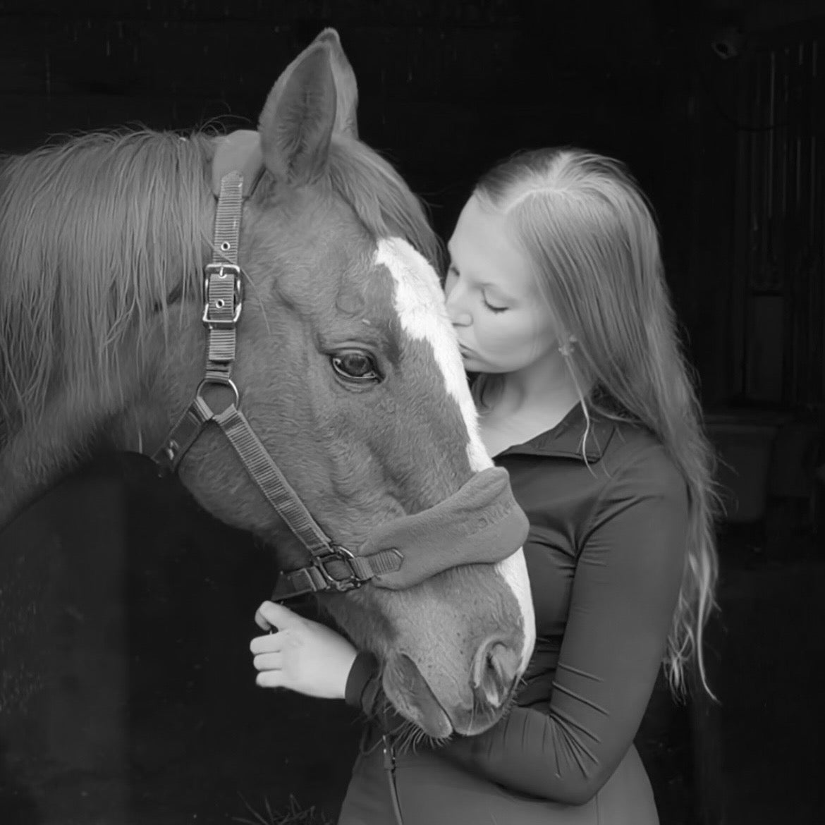 Rider kissing her horse, representing the emotional connection and love behind the equestrian lifestyle